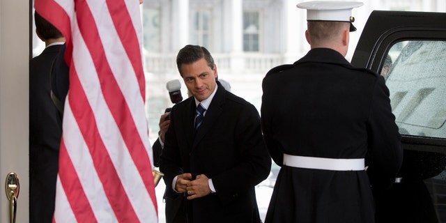 Mexico's President Enrique Pena Nieto at the White House in Washington, Tuesday, Jan. 6, 2015, for meetings with President Barack Obama. Obama is looking to his southern neighbor for help implementing the changing policies on immigration and Cuba. (AP Photo/Carolyn Kaster)