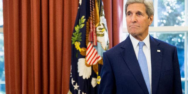 Secretary of State John Kerry is seen in the Oval Office of the White House in Washington, Tuesday, Sept. 15, 2015, as President Barack Obama and Spain's King Felipe VI conclude a bilateral meeting. (AP Photo/Andrew Harnik)