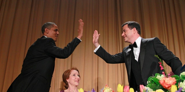 President Barack Obama high-fives late-night comic Jimmy Kimmel during the White House Correspondents Dinner, Saturday, April 28, 2012 in Washington. 