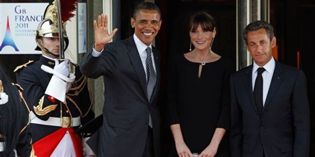 May 26: French President Nicolas Sarkozy and his wife Carla Bruni-Sarkozy welcome President Barack Obama during a dinner meeting for the G8 summit in Deauville, France.
