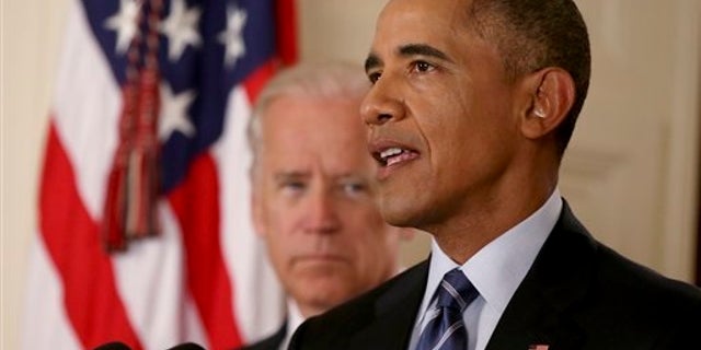 President Barack Obama, standing with Vice President Joe Biden, delivers remarks in the East Room of the White House in Washington, Tuesday, July 14, 2015, after an Iran deal is reached. Obama says every path to a nuclear weapon will be cut off from Iran under a historic agreement announced in Vienna. (AP Photo/Andrew Harnik, Pool)