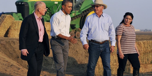 Feb. 14, 2014: President Barack Obama, second from left, walks and chats with Joe De Bosque, second from right, and his wife Maria Gloria De Bosque, far right, while California governor Jerry Brown walks at the far left, addressing drought issues on the couple's farmland south of Los Banos, Calif.