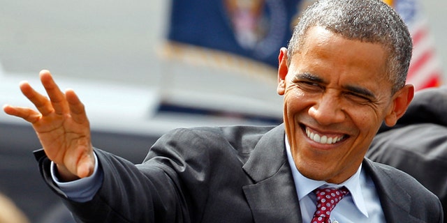President Barack Obama waves to supporters as he arrives at the Charlotte/Douglas International Airport for the Democratic National Convention in Charlotte, N.C., Wednesday, Sept. 5, 2012. (AP Photo/Chuck Burton)