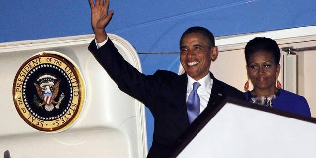 U.S. President Barack Obama and first lady Michelle Obama step off Air Force One as they arrive at London's Stansted Airport, Monday, May 23, 2011. (AP Photo/Charles Dharapak)