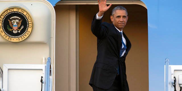 July 23, 2015: President Barack Obama waves as he boards Air Force One for a trip to Kenya and Ethiopia. Obama is the first sitting U.S. president to visit both countries. (AP Photo/Cliff Owen)