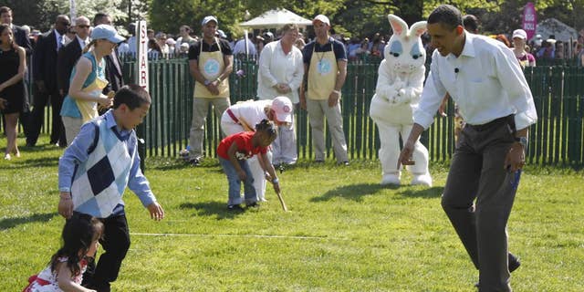 President Barack Obama cheers on children rolling Easter eggs at the White House Easter Egg Roll on the South Lawn of the White House in Washington, Monday, April 25, 2011. (AP Photo/Charles Dharapak)
