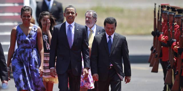 President Barack Obama, accompanied by his wife Michelle Obama and his daughters, walks upon his arrival to the international airport in San Salvador, El Salvador, Tuesday March 22, 2011.  (Photo/Dario Lopez-Mills)