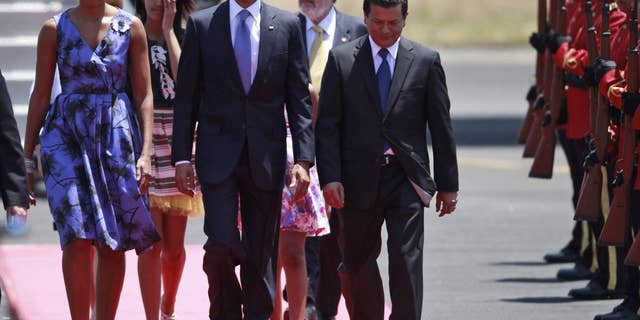 President Barack Obama, accompanied by his wife Michelle Obama and his daughters, walks upon his arrival to the international airport in San Salvador, El Salvador, Tuesday March 22, 2011. (Photo/Dario Lopez-Mills)