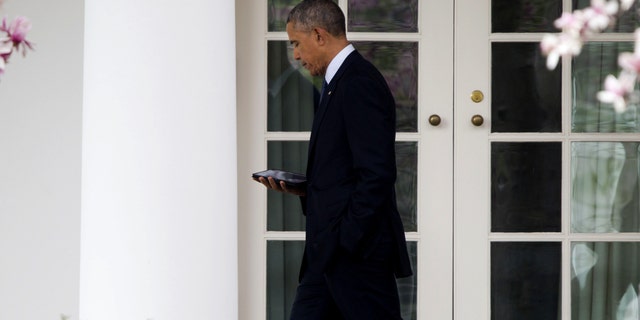 President Obama walks back to the Oval Office of the White House in Washington, Tuesday, April 7, 2015.