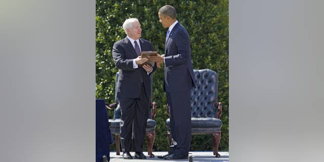 President Barack Obama presents outgoing Defense Secretary Robert Gates with the Presidential Medal of Freedom during a farewell ceremony for Gates, Thursday, June 30, 2011, at the Pentagon. (AP Photo/Evan Vucci)