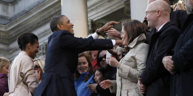 U.S. President Barack Obama and first lady Michelle Obama greet the crowd at College Green in Dublin, Ireland, Monday, May 23, 2011. (AP Photo/Charles Dharapak)