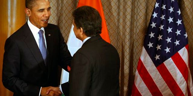 U.S. President Barack Obama, left, shakes hand with Mahindra & Mahindra Ltd. Managing Director Anand Mahindra at Obama's meeting with entrepreneurs in Mumbai, India, Saturday, Nov. 6, 2010. Obama arrived in India on Saturday, beginning a 10-day, four-country tour of Asia that will take him through some of the region's most vibrant democracies in search of U.S. economic and security benefits. (AP Photo/Rafiq Maqbool, Pool)