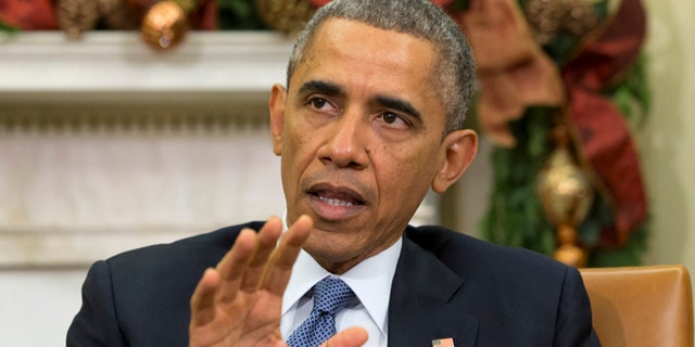 In this Friday, Dec. 5, 2014 photo President Barack Obama speaks during a meeting in the Oval Office of the White House in Washington.