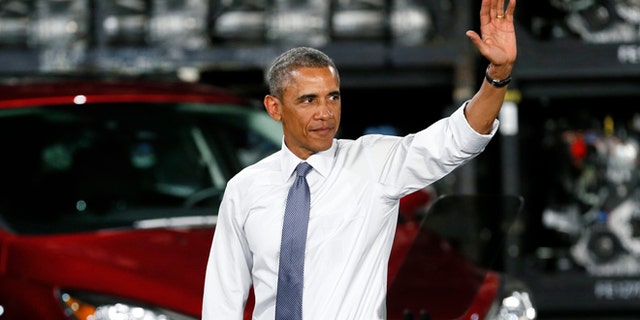 President Barack Obama waves to the audience at the Ford Michigan Assembly Plant in Wayne, Mich., Wednesday, Jan. 7, 2015.