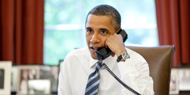 President Barack Obama talks with the crews of the Space Shuttle Atlantis and the International Space Station during a phone call in the Oval Office, July 15, 2011. (Official White House Photo by Pete Souza)