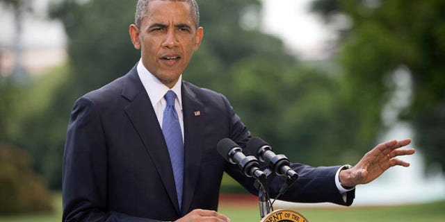 President Barack Obama talks about his administration's response to a growing insurgency foothold in Iraq, Friday, June 13, 2014, on the South Lawn of the White House in Washington.