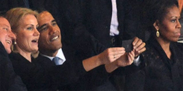 Dec. 10, 2013: President Obama is shown taking a picture alongside Danish Prime Minister Helle Thorning-Schmidt and British Prime Minister David Cameron, in Johannesburg.