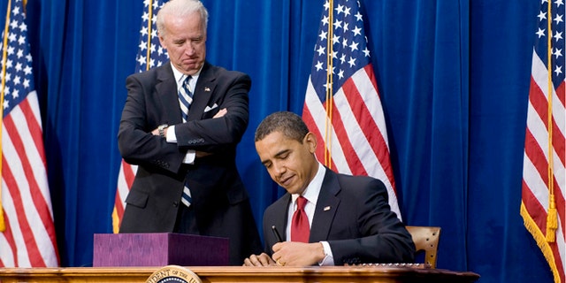 FILE: Feb. 17, 2009: President Obama signs the American Recovery and Reinvestment Act, next to Vice President Biden, in Denver, Colo.