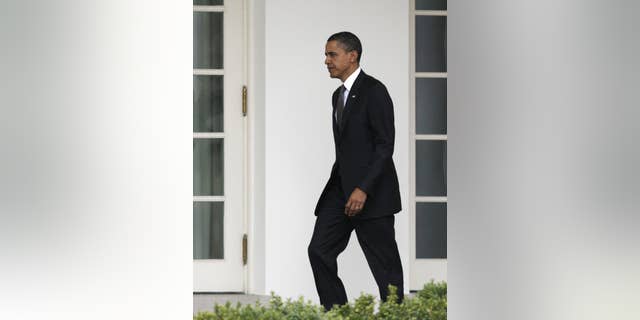 President Barack Obama walks to the Oval Office of the White House, Wednesday, March 23, 2011, in Washington, as he returns from Latin America with his family. (AP Photo/Carolyn Kaster)
