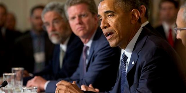 President Barack Obama speaks about a series of new actions being taken to support communities facing climate change during a meeting with state, local, and tribal leaders, Wednesday, July 16, 2014, in the State Dining Room of the White House in Washington. (AP Photo/Jacquelyn Martin)
