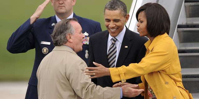President Barack Obama and first lady Michelle Obama are greeted by Chicago Mayor Richard M. Daley upon their arrival at Chicago O'Hare International Airport in Chicago, Wednesday, April 27, 2011. (AP Photo/Paul Beaty)