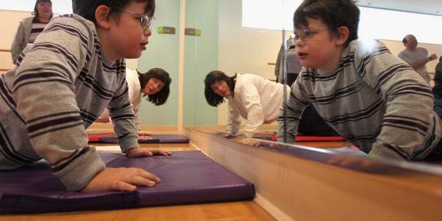 Morgan DePalma does push-ups during the Shapedown program for overweight adolescents and children in Aurora, Colorado.