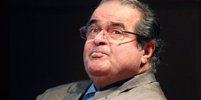 FILE - In this Oct. 18, 2011 file photo, U.S. Supreme Court justice Antonin Scalia looks into the balcony before addressing the Chicago-Kent College Law justice in Chicago. On Saturday, Feb. 13, 2016, the U.S. Marshals Service confirmed that Scalia has died at the age of 79. (AP Photo/Charles Rex Arbogast, File)