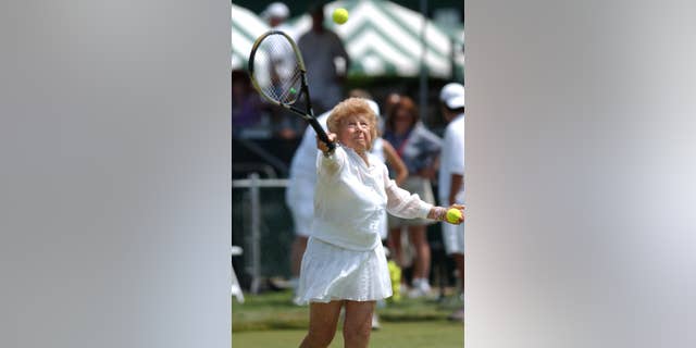 FILE - In this July 10, 2004, file photo, Tennis great Dorothy "Dodo" Cheney, 87, of Santa Monica, Calif., plays during an exhibition match prior to ceremonies celebrating the 50th anniversary of the Tennis Hall of Fame in Newport, R.I. The International Tennis Hall of Fame says Cheney, a member of the Hall and the first American woman to win the tournament now known as the Australian Open, has died at age 98. The Hall says Tuesday, Nov. 25, 2014, that Cheney died Sunday in Escondido, Calif., following a brief illness. (AP Photo/Victoria Arocho, File)
