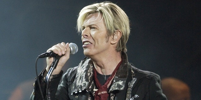 FILE - In this Dec. 15, 2003 file photo, singer/songwriter David Bowie launches his United States leg of his worldwide tour called 'A Reality Tour' at Madison Square Garden in New York. Bowie, the innovative and iconic singer whose illustrious career lasted five decades, died Monday, Jan. 11, 2016, after battling cancer for 18 months. He was 69 (AP Photo/Kathy Willens, File)