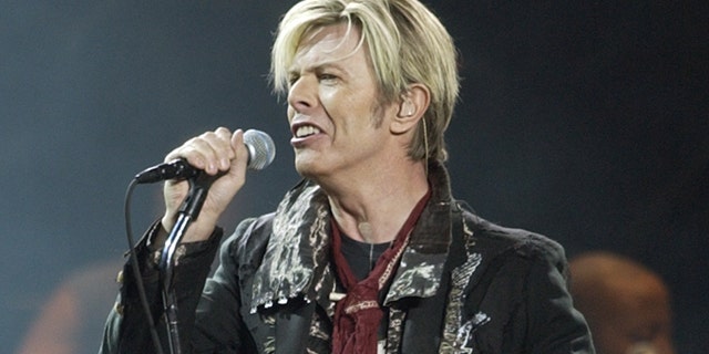 FILE - In this Dec. 15, 2003 file photo, singer/songwriter David Bowie launches his United States leg of his worldwide tour called 'A Reality Tour' at Madison Square Garden in New York. Bowie, the innovative and iconic singer whose illustrious career lasted five decades, died Monday, Jan. 11, 2016, after battling cancer for 18 months. He was 69 (AP Photo/Kathy Willens, File)