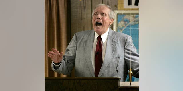 FILE - In this March 19, 2006 file photo, the Rev. Fred Phelps Sr. preaches at his Westboro Baptist Church in Topeka, Kan. Phelps, the founder of the Kansas church known for anti-gay protests and pickets at military funerals, died Thursday, March 20, 2014. He was 84. (AP Photo/Charlie Riedel, File)