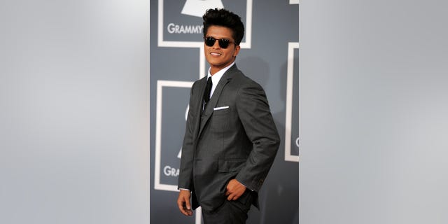 FILE - In this Feb. 12, 2012 file photo, Bruno Mars arrives at the 54th annual Grammy Awards in Los Angeles. The mother of Grammy-winning pop star Bruno Mars has died. Bernadette Hernandez died Saturday, June 1, 2013 of a brain aneurysm, according to a publicist for Mars' label, Atlantic Records, who spoke to The Associated Press on condition of anonymity because the person was not authorized to speak on the record.(AP Photo/Chris Pizzello, File)