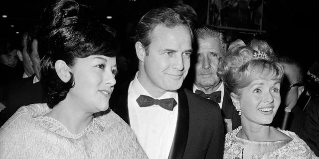 Marlon Brando, his wife, Mexican actress Movita Castaneda, left, and actress Debbie Reynolds, right, arrive for the West Coast premiere of "Mutiny on the Bounty," in Los Angeles, Nov. 15, 1962.