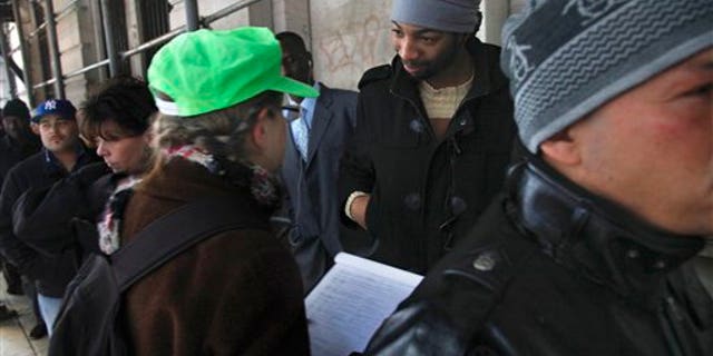 Dec. 14: Hero Vincent, second from right, an early protester in the Occupy Wall Street movement, listens as Judith Anderson, a lawyer working with the National Lawyers Guild, records information about him as he stands in line outside Manhattan Criminal Court on Wednesday.