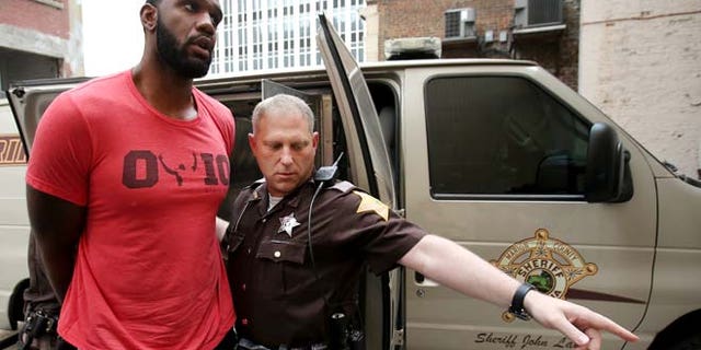 Aug. 7, 2014: Greg Oden is escorted into the Marion County Community Corrections building in Indianapolis. (AP/The Indianapolis Star)