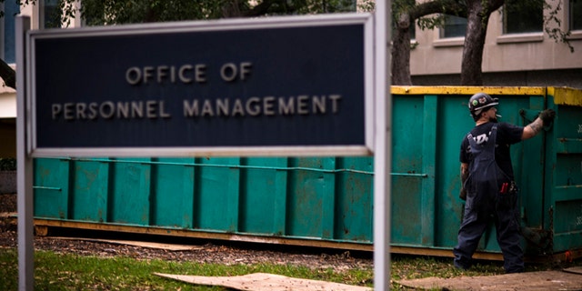 In this Thursday, Oct. 17, 2013 photo, a worker is seen at the Office of Personnel Management in Washington.