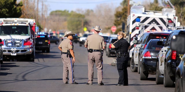 Authorities wait near an apartment complex with a barricaded suspect on Wednesday Dec. 23, 2015, in Odessa, Texas. Authorities say multiple Odessa police officers have been shot while attempting to serve a warrant at the apartment complex, with the suspect barricaded inside. (Edyta Blaszczyk/Odessa American via AP) MANDATORY CREDIT