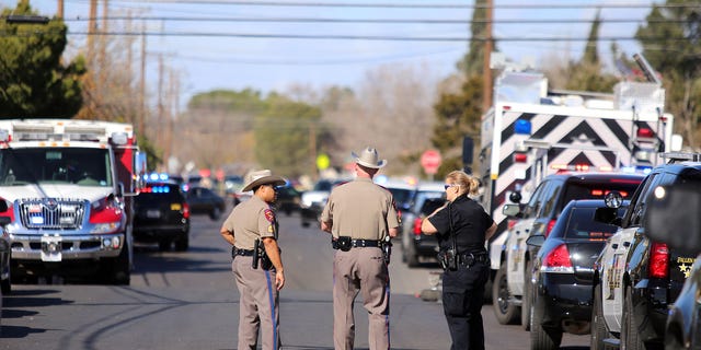 Authorities wait near an apartment complex with a barricaded suspect on Wednesday Dec. 23, 2015, in Odessa, Texas. Authorities say multiple Odessa police officers have been shot while attempting to serve a warrant at the apartment complex, with the suspect barricaded inside. (Edyta Blaszczyk/Odessa American via AP) MANDATORY CREDIT
