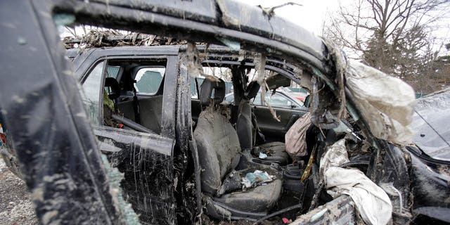 March 11, 2013: Photo in Southington, Ohio shows the vehicle where six people died in a crash early Sunday in Warren, Ohio. Two teens who escaped the crash that killed six friends in a swampy pond wriggled out of the wreckage by smashing a rear window and swimming away from the SUV, a state trooper said Monday.