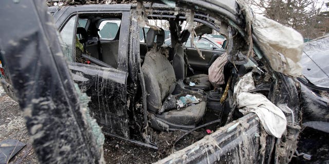 March 11, 2013: Photo in Southington, Ohio shows the vehicle where six people died in a crash early Sunday in Warren, Ohio. Two teens who escaped the crash that killed six friends in a swampy pond wriggled out of the wreckage by smashing a rear window and swimming away from the SUV, a state trooper said Monday.