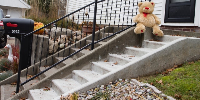 Nov. 13, 2012: A lone teddy bear sits on the steps of the home where three children, their uncle, and their grandmother were found dead inside a garage Monday in what appears to be a murder-suicide amid a custody dispute in Toledo, Ohio.