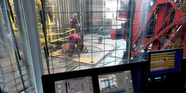 Sept. 18: Workers on the drilling floor are seen on from the window of the drilling cage as the drilling pipe is removed on the Development Driller III which drilled the relief well and pumped cement to seal the Macondo well.