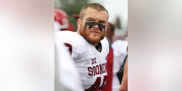 FILE - In this Sept. 6, 2014, file photo, Oklahoma fullback Aaron Ripkowski (48) watches from the sideline during an NCAA football game against Tulsa in Tulsa, Okla. Ripkowski, Oklahoma's blocking fullback, rarely gets carries. But he gets plenty of praise from coach Bob Stoops and the coaching staff for his physical play. (AP Photo/Sue Ogrocki, File)