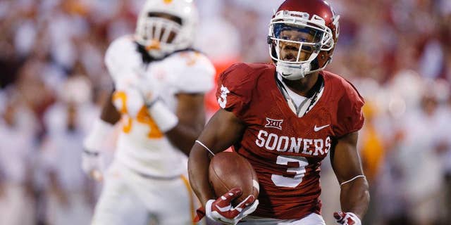 FILE - In this Sept. 13, 2014, file photo, Oklahoma wide receiver Sterling Shepard (3) carries during an NCAA college football game against Tennessee in Norman, Okla. With all the hype about freshman running back Samaje Perine, Sterling Shepard was an afterthought during Oklahoma's win over West Virginia. The junior has been the Sooners' most consistent offensive player, and he's coming off his third game with at least 100 yards receiving. (AP Photo/Sue Ogrocki, File)