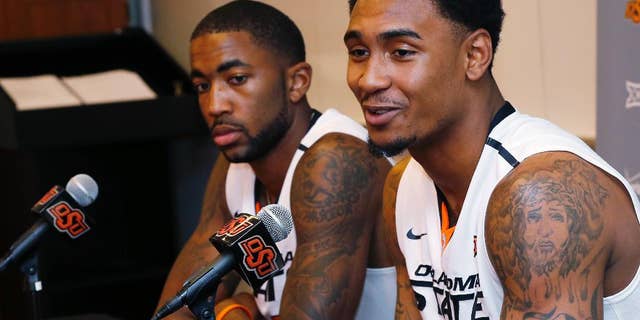 Oklahoma State post Michael Cobbins, left, and wing Le'Bryan Nash, right, answer questions during an NCAA college basketball media day in Stillwater, Okla., Monday, Oct. 20, 2014. (AP Photo/Sue Ogrocki)