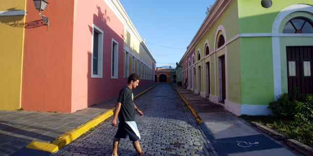 SAN JUAN, PUERTO RICO- APRIL 25: Colorful homes line the cobblestoned streets April 25, 2004 in Old San Juan, the original capital city of San Juan, Puerto Rico. The old city is a historic district of seven square blocks made up of ancient buildings and colonial homes, massive stone walls and vast fortifications, sunny parks and cobblestoned streets. (Photo by Joe Raedle/Getty Images)