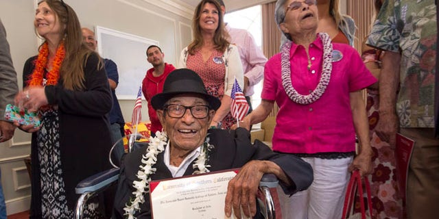 Alfonso Gonzales, 96, University of Southern California's oldest graduating Trojan receives his Bachelor of Science degree in zoology diploma from USC surrounded by family members, as part of the 2016 USC Commencement ceremony, on Friday, May 13, 2016 in Los Angeles. The World War II veteran thought he'd already graduated when he skipped commencement exercises in 1953 because of work obligations. He was founding a soil company that he ran for 55 years. But when relatives recently approached USC about getting a copy of his diploma, they learned he was one unit short. Although the school no longer offers a zoology major, it crafted an independent study course through the gerontology school that included reading, video assignments, visiting other classes, and writing a thesis about his life. (Gus Ruelas/USC via AP)