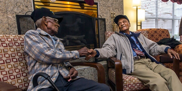 Dec. 13, 2013: Richard Overton, 107, left, and Elmer Hill, 107, center, shake hands before Austin Texas Mayor Lee Leffingwell, right, presents a proclamation acknowledging and thanking Overton, and Hill for their service.