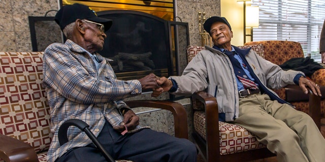 Dec. 13, 2013: Richard Overton, 107, left, and Elmer Hill, 107, center, shake hands before Austin Texas Mayor Lee Leffingwell, right, presents a proclamation acknowledging and thanking Overton, and Hill for their service.