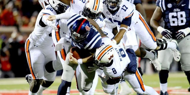 Nov 1, 2014; Oxford, MS, USA; Ole Miss Rebels quarterback Bo Wallace (14) is tackled by Auburn Tigers linebacker Cassanova McKinzy (8) during the second quarter at Vaught-Hemingway Stadium. Mandatory Credit: Shanna Lockwood-USA TODAY Sports